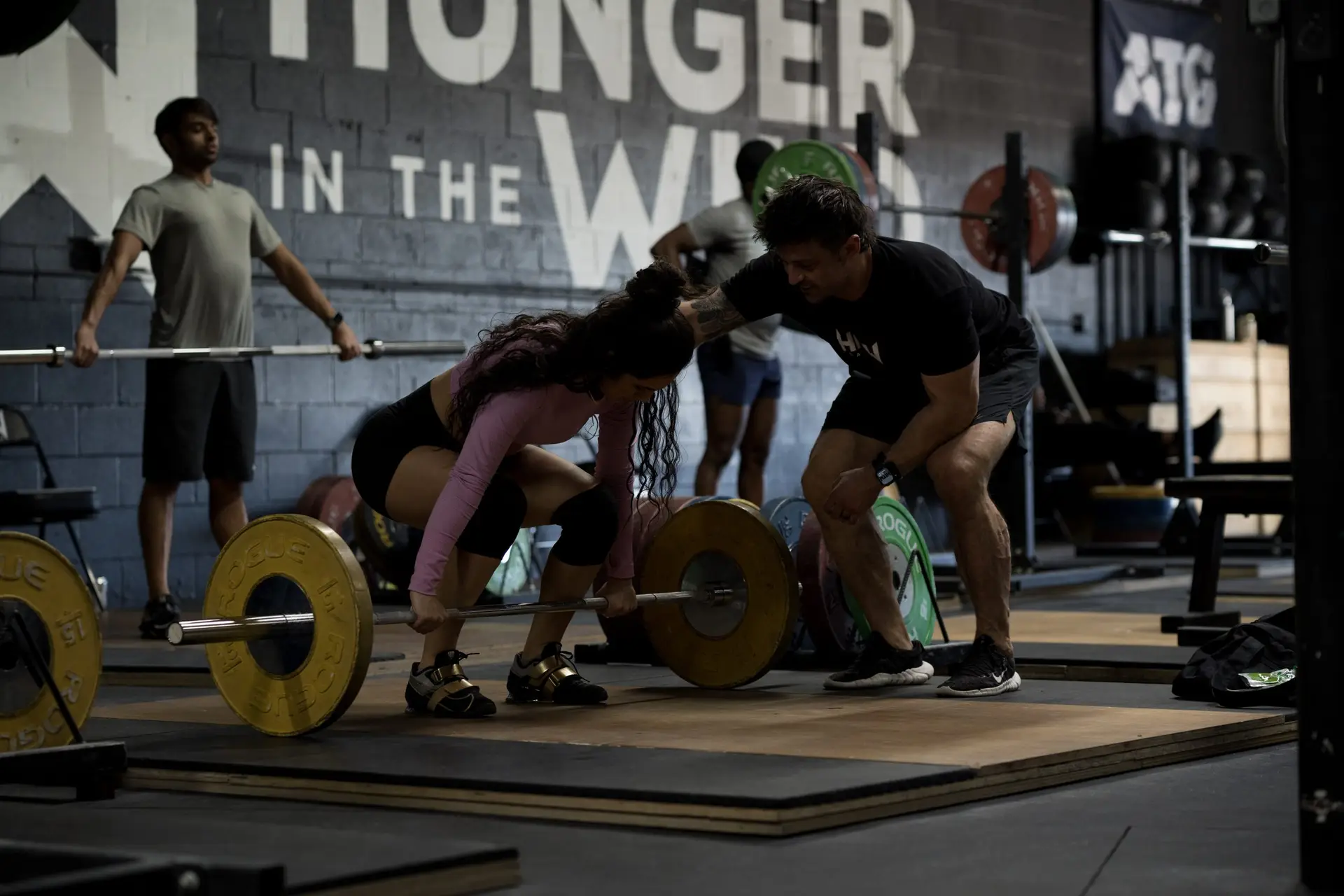 How to start strength training — beginner learning to squat with a coach at Hunger in the Wild Gym in Dallas