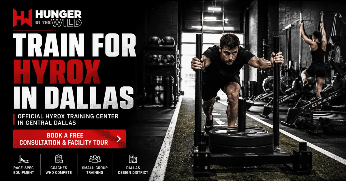 Where to Train for HYROX in Dallas: How to Choose a HYROX Training Gym HYROX athlete drives a weighted sled down an indoor turf lane at Hunger in the Wild Gym, promoting official HYROX training in Dallas.