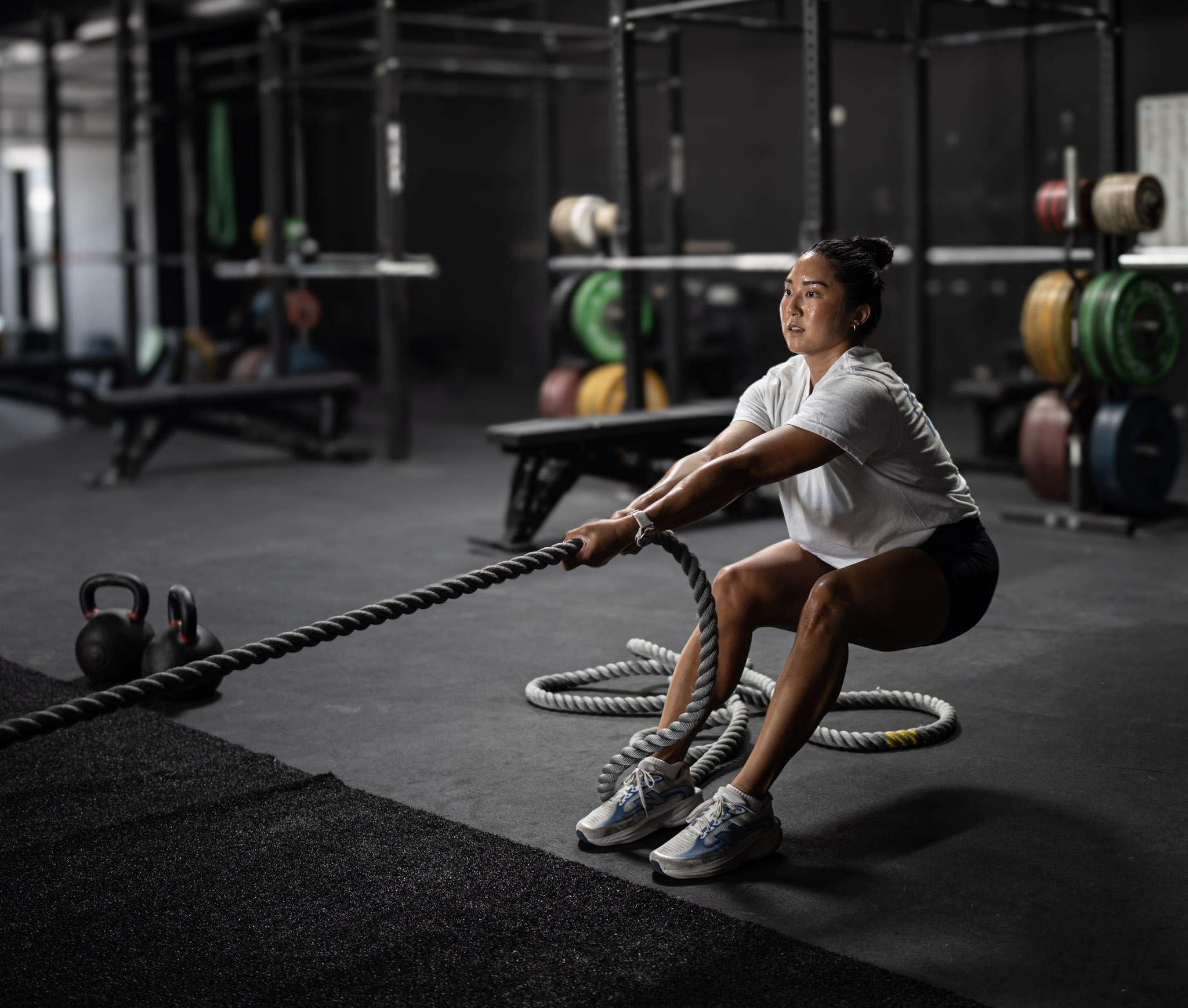HYROX Weights by Division: Every Station, Every Category (KG & LBS) Athlete leaning back into a hand-over-hand sled pull during HYROX class at our Dallas gym