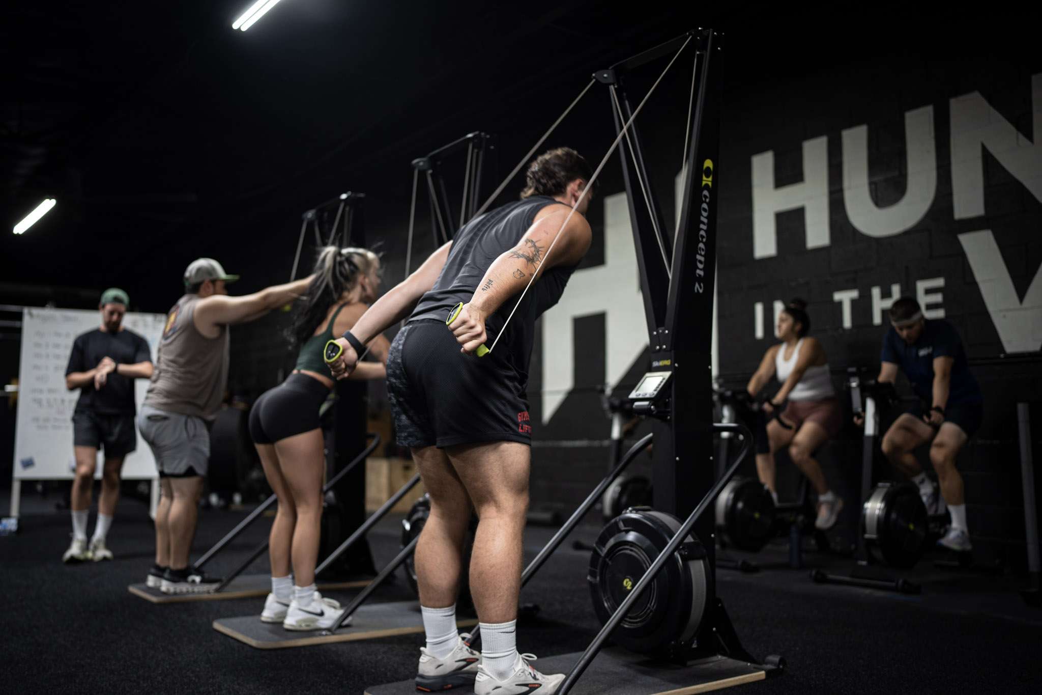 The Complete Guide to All 8 HYROX Stations (In Order) Group HYROX class working intervals on Concept2 SkiErgs at Hunger in the Wild Dallas