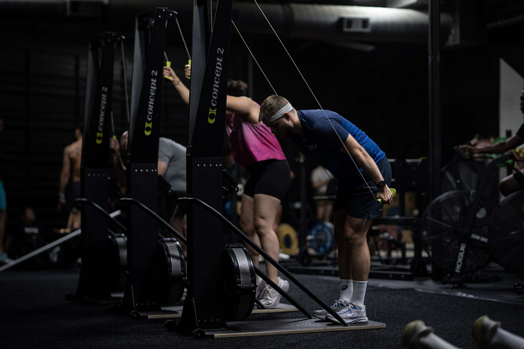 Athlete catching his breath at the SkiErg between intervals during HYROX training at Hunger in the Wild Gym in Dallas