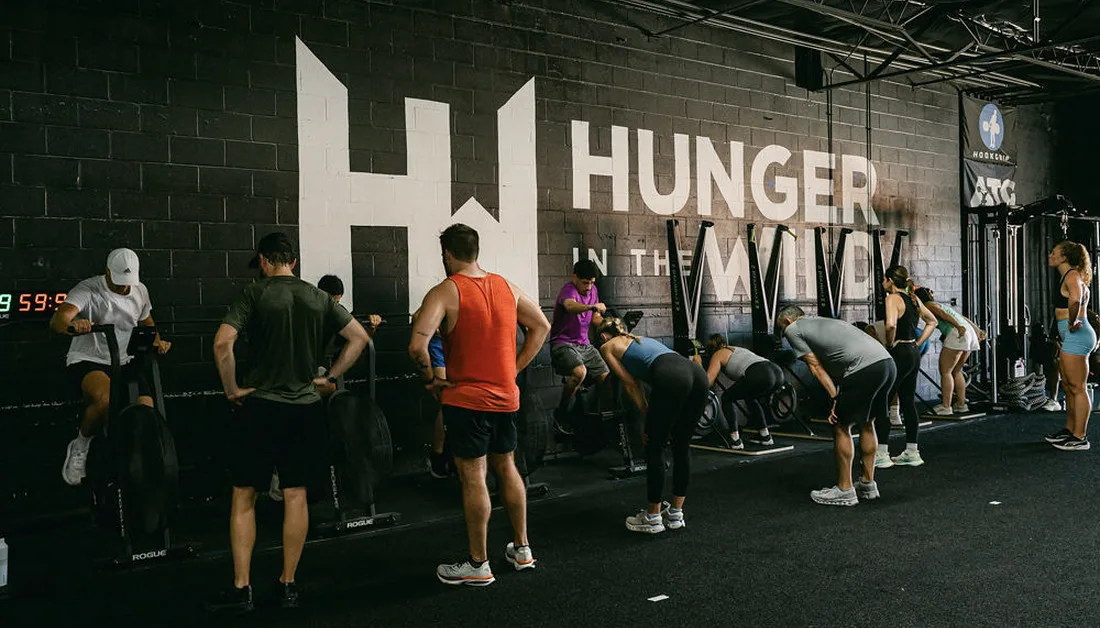 Weightlifting Weight Classes in Dallas: How They Work and Where to Train Members training together on the gym floor at Hunger in the Wild Gym.