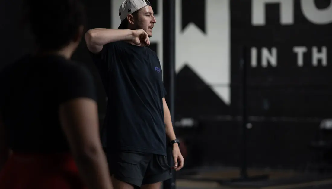 Starting Strength Training: What the First Six Months Actually Look Like A coach works with athletes during a training session at Hunger in the Wild Gym in Dallas.