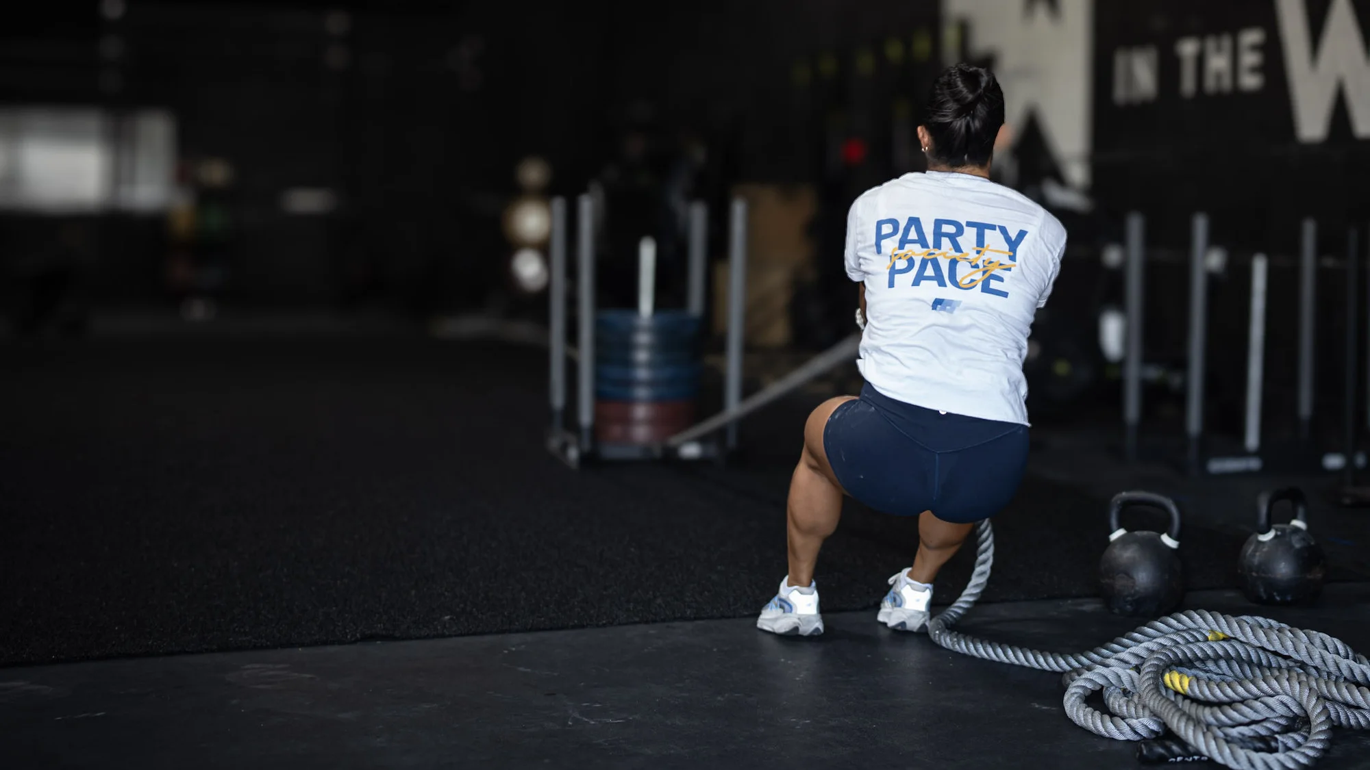The Best Personal Training Gym in Dallas for Strength and Athletic Performance Athlete pulling a weighted sled by rope at Hunger in the Wild Gym.