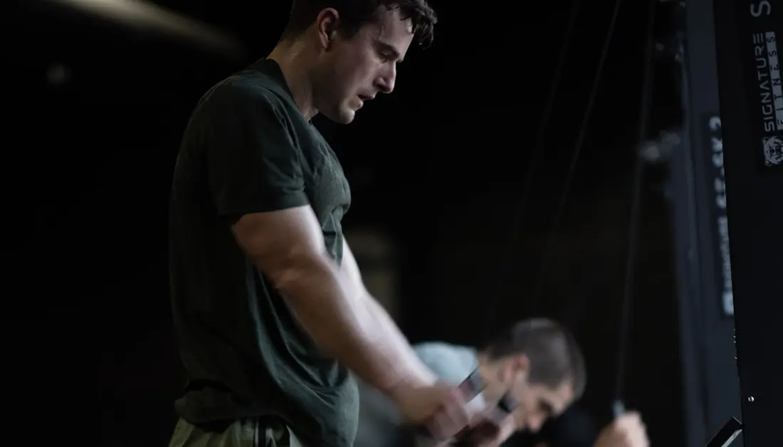 Can You Use HYROX Training to Prepare for a DEKA Event? An athlete trains on a SkiErg at Hunger in the Wild Gym in Dallas.