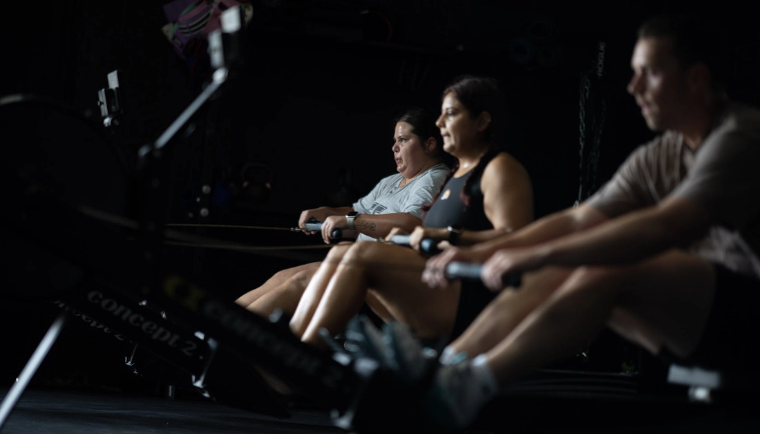 Small-Group Strength Training in Dallas: Built for Serious Athletes Athletes rowing side by side during group conditioning at Hunger in the Wild Gym.