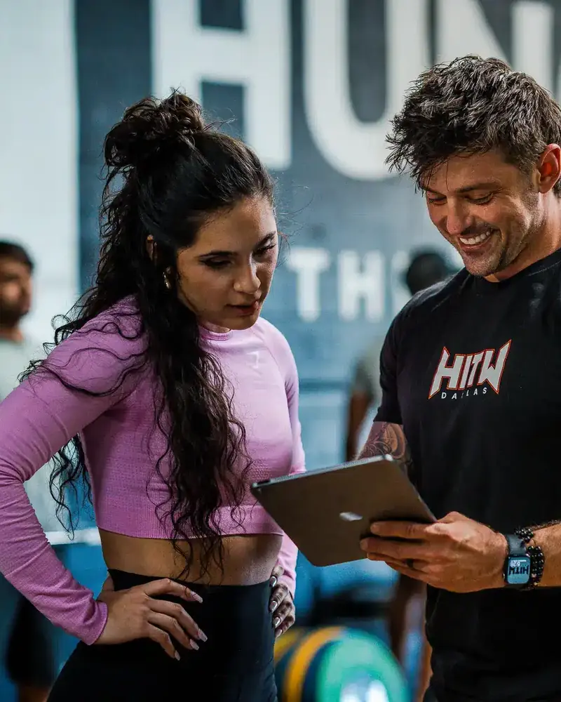 Coach reviewing a training plan with a client at Hunger in the Wild